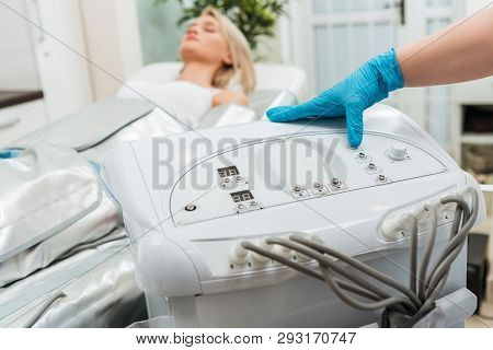 Cropped View Of Cosmetologist Setting Up Machine For Pressotherapy