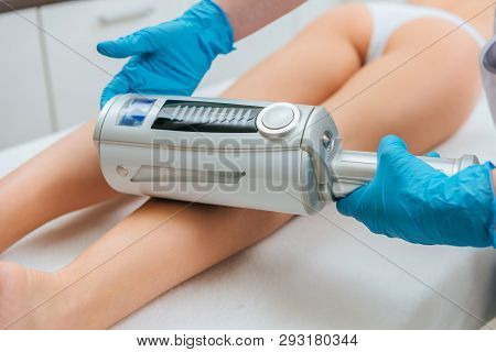 Cropped View Of Cosmetologist Doing Endospheres Therapy For Leg