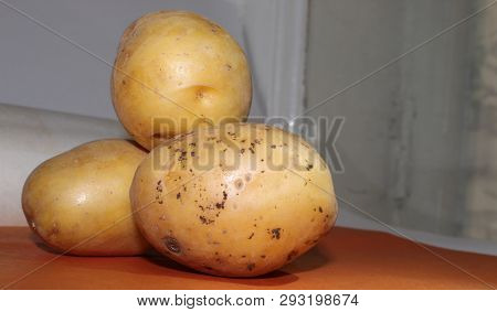 Slide Of Potatoes Lies On A Brown Background