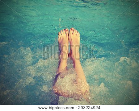 Feet Of Young Woman During The Whirlpool Therapy In The Pool With Old Toned Effect