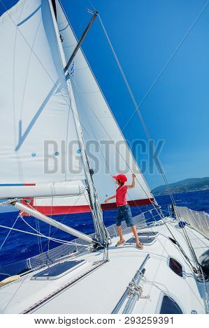 Little Boy On Board Of Sailing Yacht On Summer Cruise. Travel Adventure, Yachting With Child On Fami