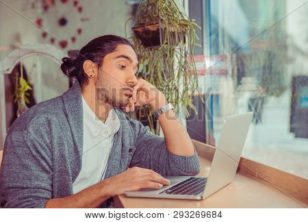Bored Man Looking At Laptop Tired. Closeup Portrait Of A Handsome Guy Wearing Formal White Shirt And