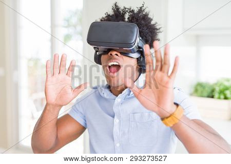African amaerican man having fun playing with virtual reality glasses