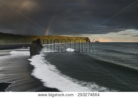 Black Sand Beach Reynisfjara in Iceland. Windy Morning. Ocean Waves. Colorful Sky. Morning Sunset.