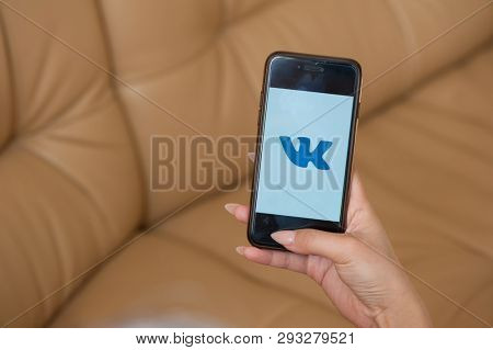 Saint-Petersburg / Russian Federation - 27 March 2019: Female hand with manicure holding cellphone with VK