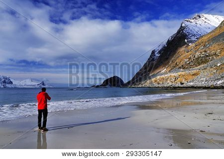 Landscape photographer on Haukland Beach in Lofoten Archipelago, Norway, Europe