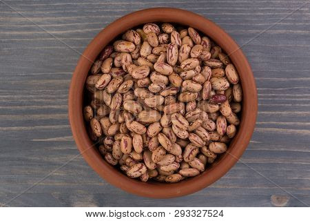 A Plate Of Beans On Wooden Table Background