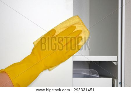 Household Chores. Wipes Dust White Furniture With Cleaning Rag. Maid Cleans House. Cleaning Or Regul