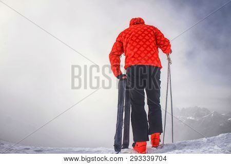 Skier Stay With Skis On Mountain Edge Above Deep Slope Valley. Fearless Man