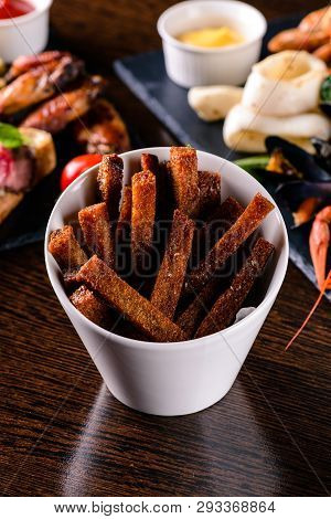 Stack Of Crispy Rye Crouton Bread Biscuits Crackers Snacks On A Wooden Table, Brown Bread Croutons