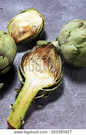 Artichokes On Rustic Background. Fresh Organic Artichoke Flower Set