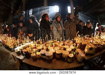 Blagoevgrad, Bulgaria - February 10, 2019: Worshippers Light Candles On Jars With Honey During A Rel