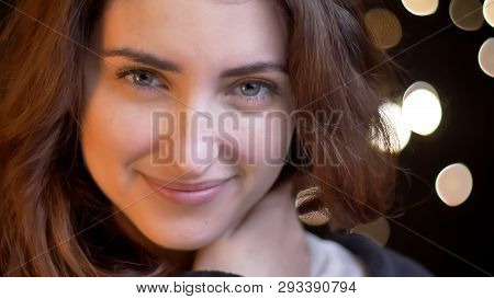 Closeup Shoot Of Young Attractive Caucasian Female Smiling Seductively And Looking Straight At Camer