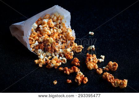 Popcorn Scattered From The White Bag With Black Background
