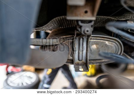 The Exhaust System In The Car Seen From Below, The Car Is On The Lift In The Car Workshop.