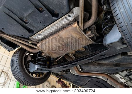 The Exhaust System In The Car Seen From Below, The Car Is On The Lift In The Car Workshop.
