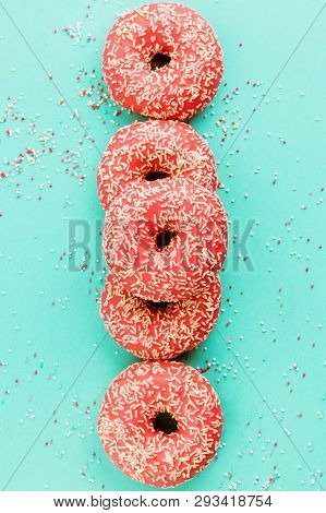 Donuts Decorated With Icing On Blue Background.
