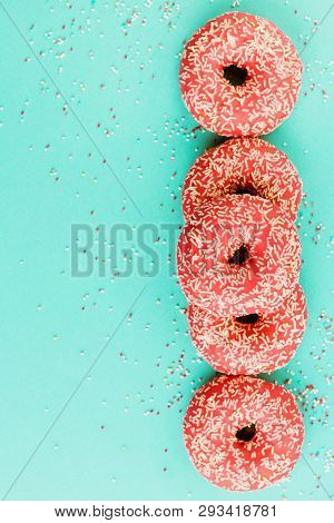 Donuts Decorated With Icing On Blue Background.