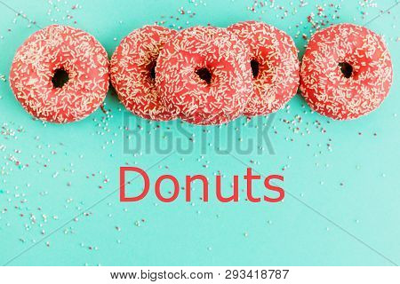 Donuts Decorated With Icing On Blue Background.