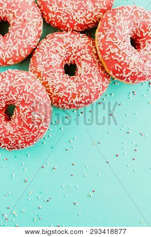 Donuts Decorated With Icing On Blue Background.