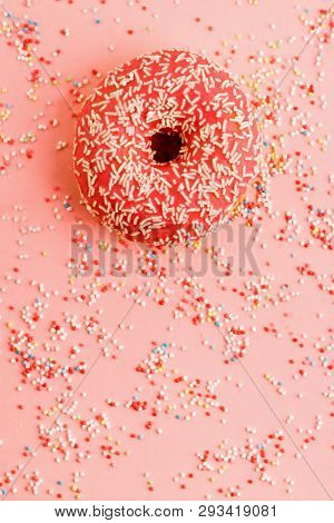 Coral Donut Lying On Pink. Donut Decorated With Icing On Pink.