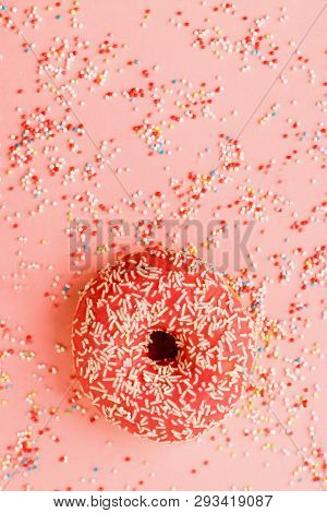 Coral Donut Lying On Pink. Donut Decorated With Icing On Pink.