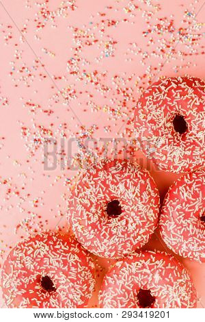 Five Coral Donuts Lying In A Corner.