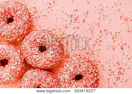 Five Coral Donuts Lying In A Corner.