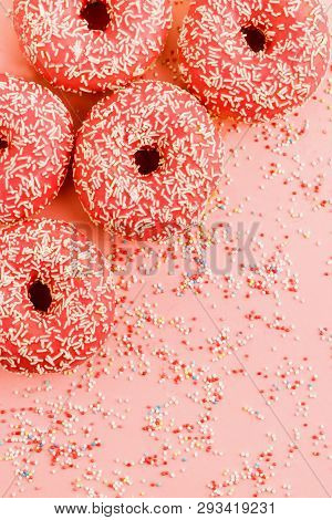 Five Coral Donuts Lying In A Corner.