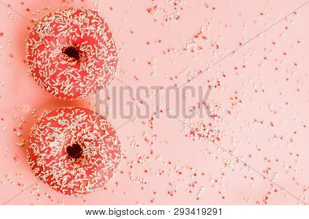 Two Coral Donuts. Donuts With Icing On Pink Background.