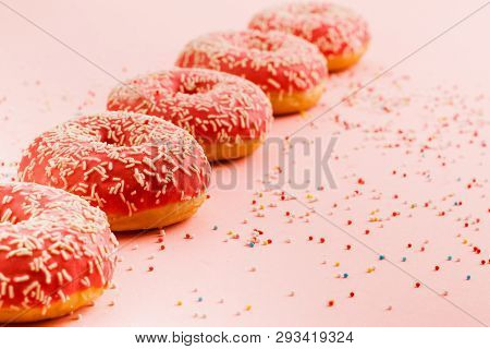 Five Coral Donuts Standing In A Line. Donuts With Icing