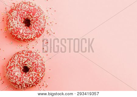 Two Coral Donuts. Donuts With Icing On Pink Background.