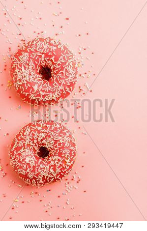 Two Coral Donuts. Donuts With Icing On Pink Background.