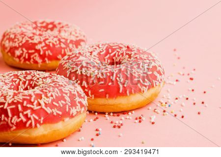 Coral Donuts. Donuts Decorated With Icing On Pink Background.