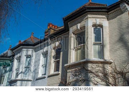 The Afternoon Sun Shines Through A Beautiful White Brick House In The Chiswick Area Of ​​london.