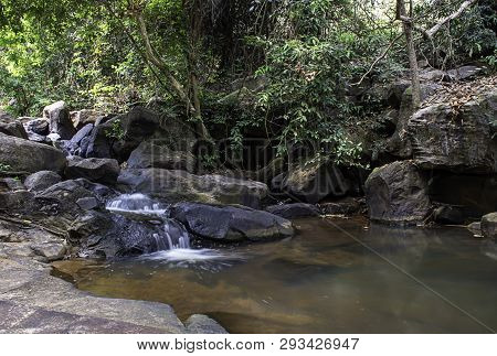 The Water Flowing Over Rocks And Trees Down A Waterfall At Khao Ito Waterfall , Prachin Buri In Thai
