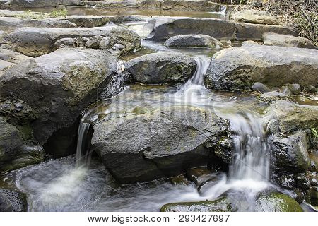 The Water Flowing Over Rocks And Trees Down A Waterfall At Khao Ito Waterfall , Prachin Buri In Thai