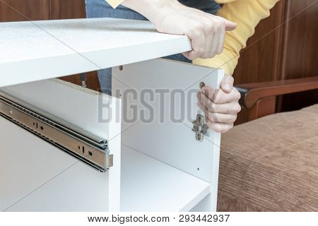 Woman Mounting New White Furniture, She Putting A Tabletop On A New Half Assembled Dressing Table