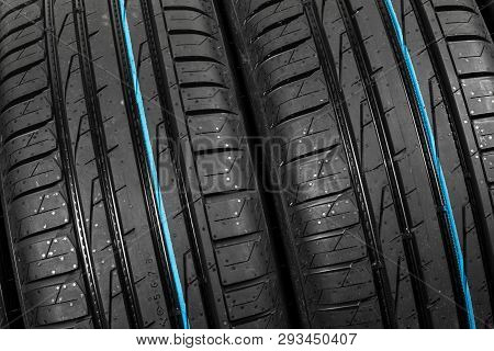 Studio Shot Of A Set Of Summer Car Tires On Black Background. Tire Stack Background. Selective Focus