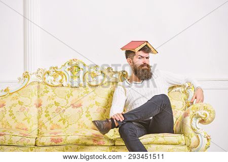 Macho Sits With Open Book On Head, Like Roof. Guy, Teacher Overdid With Teaching, Became Crazy Profe