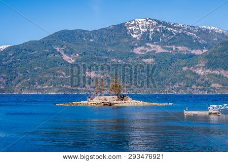 Fantastic view over ocean, snow mountain and rocks at Sechelt inlet in Vancouver, Canada.