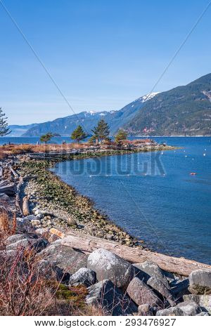Fantastic view over ocean, snow mountain and rocks at Sechelt inlet in Vancouver, Canada.