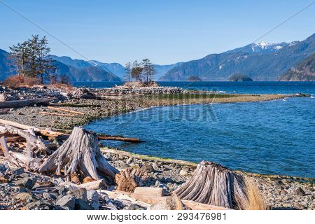 Fantastic view over ocean, snow mountain and rocks at Sechelt inlet in Vancouver, Canada.