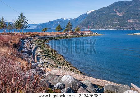 Fantastic view over ocean, snow mountain and rocks at Sechelt inlet in Vancouver, Canada.