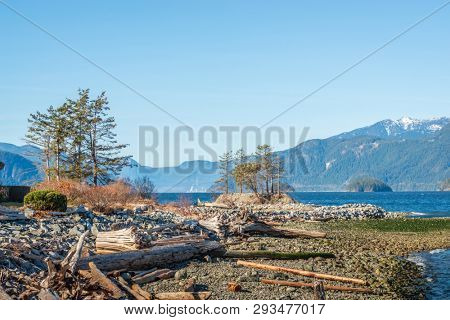 Fantastic view over ocean, snow mountain and rocks at Sechelt inlet in Vancouver, Canada.