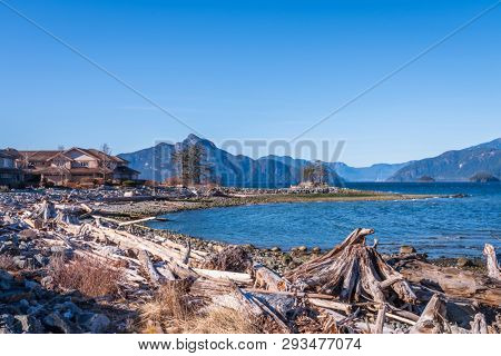 Fantastic view over ocean, snow mountain and rocks at Sechelt inlet in Vancouver, Canada.