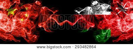 China Vs Oman, Omani Smoke Flags Placed Side By Side. Thick Colored Silky Smoke Flags Of Chinese And