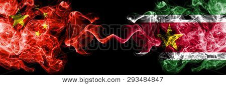 China Vs Suriname, Surinamese Smoke Flags Placed Side By Side. Thick Colored Silky Smoke Flags Of Ch