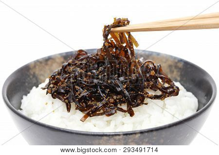 Japanese Food, Tsukudani Of Konbu On Cooked White Rice On White Background