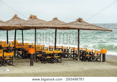 Empty beach outdoor cafe at low season with bad weather with no people. Leptokaria, Makedonia, Greece